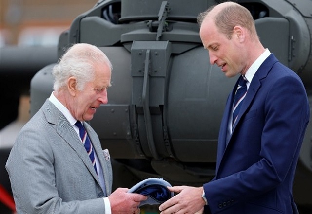 Prince William and King Charlse Standing In Front of An Helicopter